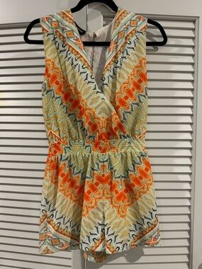 bebe Multicolor Floral Print Sleeveless Shorts Romper with Orange Accents